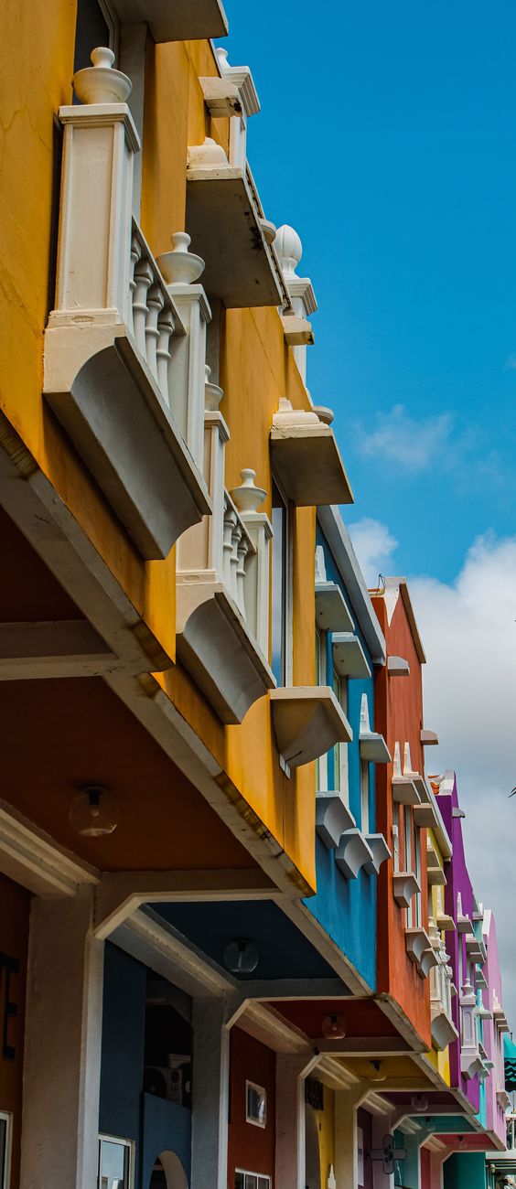 Colorful seaside houses — the kind of place Tash sends you